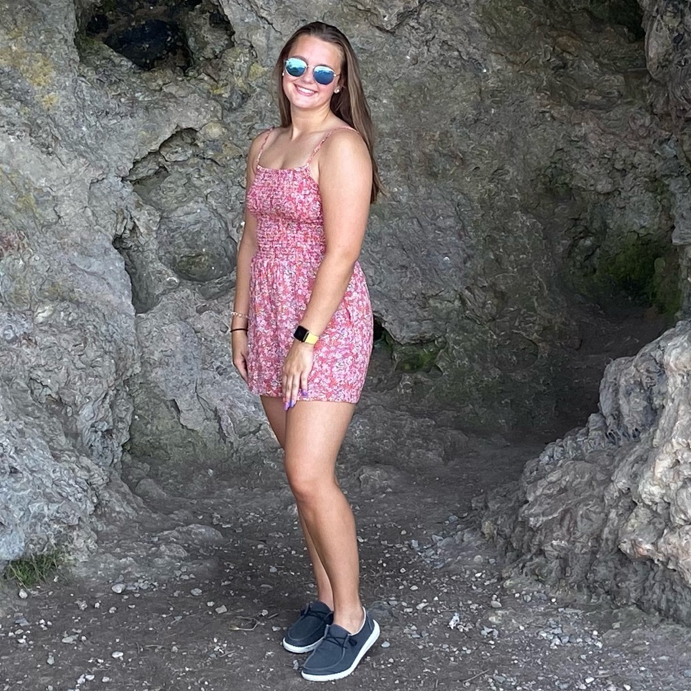Red romper with flour details in a size medium